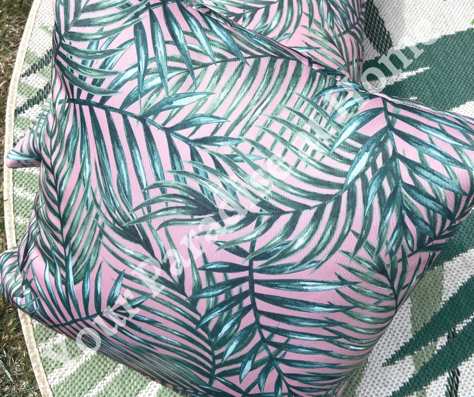 Palm leaves on blush pink background outdoor cushion for your garden. Weatherproof fabric is water resistant and UV resistant. Cushion covers are zipped and washable.